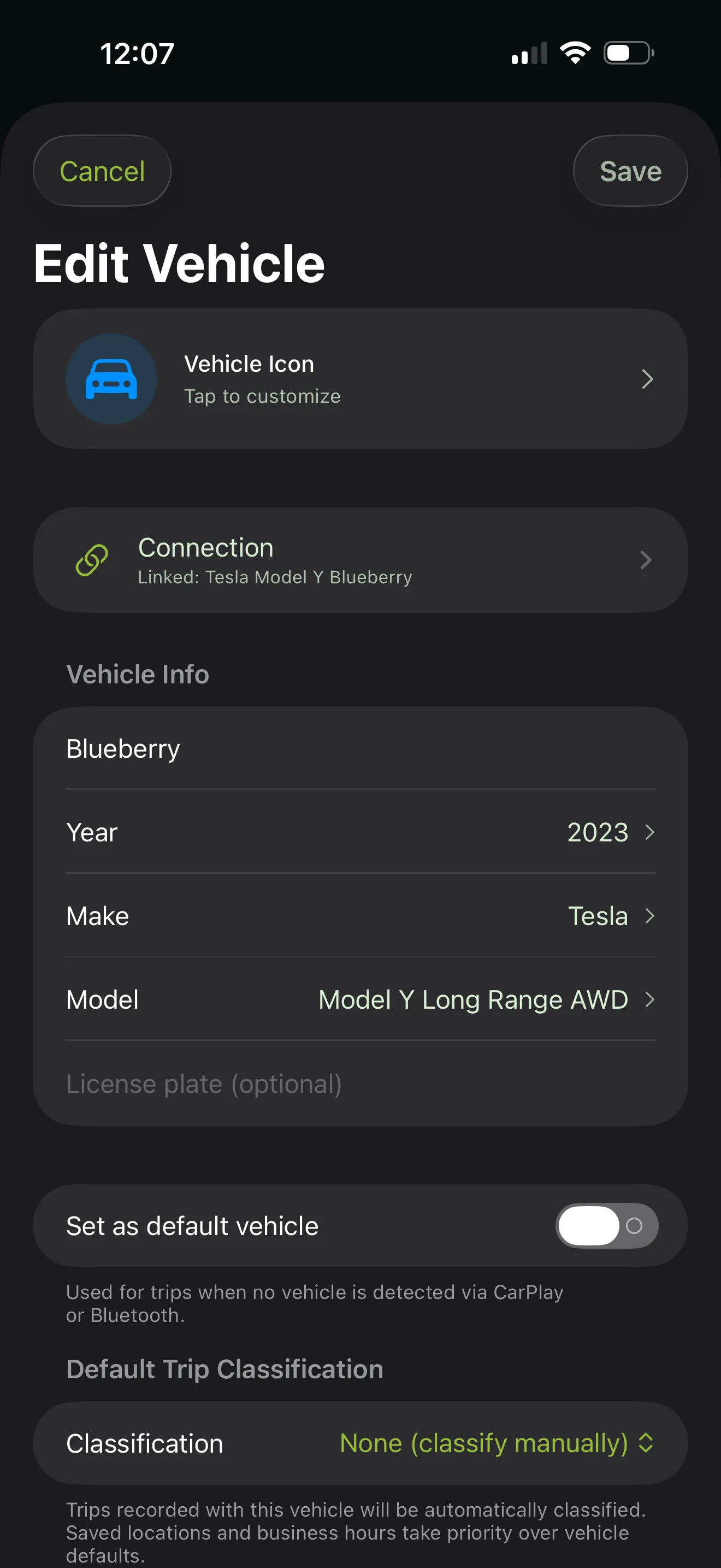 Edit Vehicle screen for a 2023 Tesla Model Y Long Range AWD — vehicle icon, CarPlay/Bluetooth connection (Tesla Model Y Blueberry), license plate, default vehicle toggle, and default trip classification controls